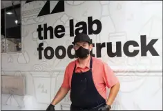  ?? (Arkansas Democrat-Gazette/Cary Jenkins) ?? Chef Gilbert Alaquinez poses in front of the Lab Food Truck at a July event at Historic Arkansas Museum.