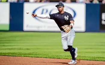  ?? Charlie Neibergall/associated Press ?? Yankees infielder Oswald Peraza throws to first base during the first inning against the Rays on Wednesday. Peraza had a second MRI on his shoulder Friday.