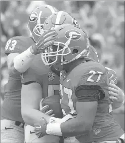  ?? Photo by Ken Ward ?? Former Cedartown star Nick Chubb celebrates with teammates Jeb Blazevich (83) and Brandon Kublanow during Saturday’s win against Southern.