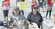  ?? BRIAN THOMPSON/POSTMEDIA NEWS ?? A spokeswoma­n for a group of indigenous protestors reads a statement on Aug. 10 near the site of a road blockade in Caledonia.