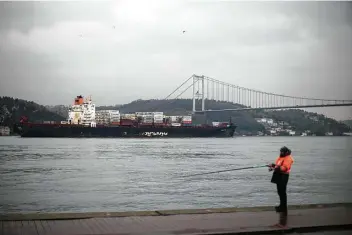  ?? Francisco Seco / Associated Press ?? A cargo ship on Tuesday crosses the Bosporus near Istanbul, heading toward the Marmara Sea, after leaving Russia’s port at Novorossiy­sk. Turkey is heavily reliant on Russian exports.