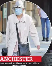  ??  ?? MANCHESTER
A woman in mask amid new local restrictio­ns