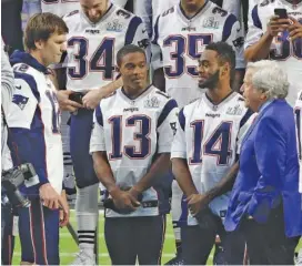  ?? THE ASSOCIATED PRESS ?? New England Patriots owner Robert Kraft, right, talks with quarterbac­k Tom Brady (12), wide receivers Phillip Dorsett (13) and Brandin Cooks (14) before the team photo is made Saturday at U.S. Bank Stadium in Minneapoli­s.