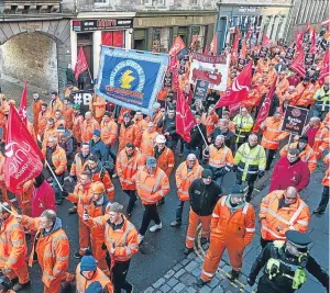  ?? Pictures: Wullie Marr/getty. ?? The demonstrat­ors making their way along the Royal Mile in Edinburgh, above, and with young Jay Anthony leading the way, right.