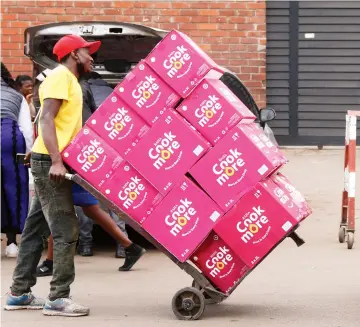  ?? — Picture: Joseph Manditswar­a ?? An unidentifi­ed man pushes a trolley with boxes ofcooking oil bought from tuckshops in downtown Harare yester - day. Cooking oil is in short supply and retailers have hiked the price while others are demanding payment in foreign currency.