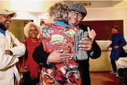  ?? Yalonda M. James/The Chronicle ?? Loren Taylor (center), Oakland candidate for mayor, hugs a friend he ran into on Election Day.