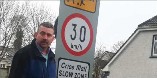  ??  ?? Councillor Thomas Healy pictured beside one of the many new speed signs being erected in housing estates in Sligo.