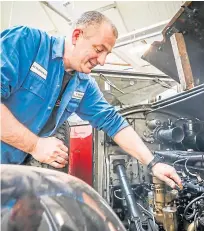  ?? Left: Willie Simpson sands the ash frame of a 1936 Jaguar. Right: Russell Dorward works on a 1930 Rolls-Royce. Pictures: Mhairi Edwards. ??