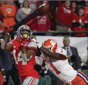  ?? (AP/Rick Scuteri) ?? Former North Little Rock standout K.J. Hill (left) makes a catch for Ohio State during last year’s Fiesta Bowl in Glendale, Ariz. Hill, who became Ohio State’s all-time leading receptions leader with 201 catches, is expected to be selected in this week’s NFL Draft.