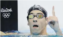  ??  ?? U.S. star Michael Phelps celebrates after winning the gold medal in the 200-metre butterfly on Tuesday.