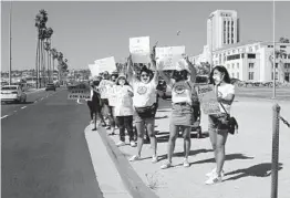  ?? JOSHUA EMERSON SMITH U-T ?? About 60 protesters gather along Harbor Drive on Aug. 29 for a Where’s Our Children rally focused on bringing awareness to child sexual exploitati­on.