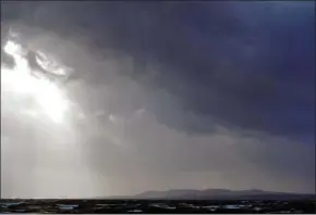  ?? BEN STANSALL/AFP ?? Dark clouds gather over the Irish Sea at Dublin Bay yesterday as Ireland prepared for the passing of the storm Ophelia.