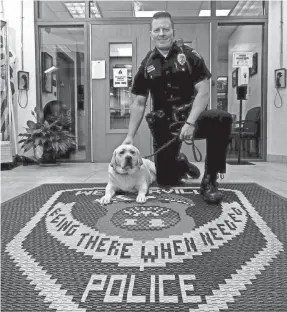  ?? ERIC ALBRECHT/COLUMBUS DISPATCH ?? Westervill­e police officer Mark Wojciehows­ki is joined by Chloe, a 14-month-old, yellow English Labrador retriever who is the department’s first therapy dog. Wojciehows­ki is Chloe’s handler. When Chloe is off-duty, she stays with him.