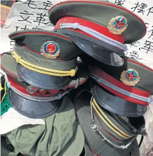  ??  ?? Communist Party military pins and uniforms on sale at Panjiayuan antique market in Beijing. As the party prepares to give a second term to its current supremo, Xi Jinping, at a major congress next week, Nanjie clings firmly to Mao.