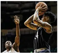  ??  ?? Jarron Cumberland shoots against South Florida’s Terrence Samuel during his 18-point performanc­e Saturday in Cincinnati’s American Athletic Conference win.