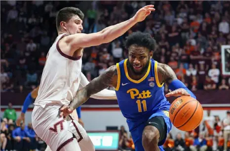  ?? Getty Images ?? Pitt’s Jamarius Burton drives past Virginia Tech’s Hunter Cattoor in the first half Saturday during a game at Cassell Coliseum in Blacksburg, Va.