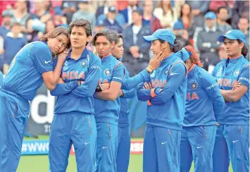  ??  ?? The Indian women look dejected after suffering a heart-breaking defeat at the hands of England in the World Cup final on Sunday. — AP