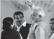  ??  ?? BJP leaders Sushma Swaraj and Nitin Gadkari with Narendra Modi at the party headquarte­rs in New Delhi. —