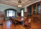  ??  ?? A decorative plaster tray ceiling and a built-in china cabinet add appeal in the formal dining room.