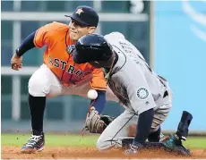  ?? ERIC CHRISTIAN SMITH/ THE ASSOCIATED PRESS ?? Seattle Mariner Ketel Marte steals second base as Houston Astros shortstop Carlos Correa tries to apply the tag during their game in Houston, Friday night.