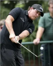  ?? JEFF SINER - THE ASSOCIATED PRESS ?? Phil Mickelson watches the flight of his ball during practice for the PGA Championsh­ip golf tournament at Quail Hollow Club in Charlotte, N.C., on Monday.