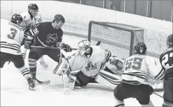  ?? CAROLE MORRIS-UNDERHILL ?? Manuel Manero watches as the puck he shot bests the Penguins’ Ryan Huestis.