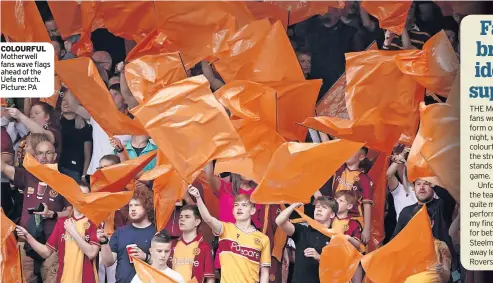  ?? ?? COLOURFUL Motherwell fans wave flags ahead of the Uefa match. Picture: PA