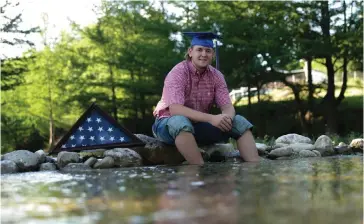  ?? Associated Press ?? ■ Medina High School graduate Gavin Walters poses for a photo near his home in Medina, Texas, on May 26. Gavin’s father, Gary Walters Jr., a corporal in the Army, died in Iraq in 2005 when Gavin was just 3 years old.