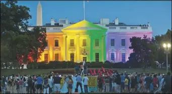  ?? ASSOCIATED PRESS ?? In this 2015 file photo, people gather in Lafayette Park in Washington to see the White House illuminate­d with rainbow colors in commemorat­ion of the Supreme Court’s ruling to legalize same-sex marriage.