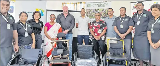  ?? Picture: WATA SHAW ?? Ministry of Education permanent secretary Anjeela Jokhan, fourth from left, and Health Ministry permanent secretary Dr James Fong,
seventh from left, with staff members from the Frank Hilton Organizati­on.