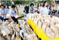  ??  ?? Members of the Davao Bakers Club getting ready to distribute the bread that are especially made for the senior citizens.