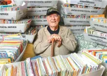  ?? AP-Yonhap ?? Duane Sherman, 96, poses at home with a small fraction of the 50,000 birthday cards he’s received after his daughter’s social media request for people to send him cards to cheer him up on his birthday went viral in Fullerton, Calif., Jan. 8.