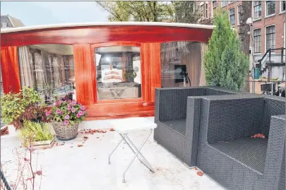  ?? STEVE MACNAULL PHOTO ?? Travel writer Steve MacNaull stayed in this canal boat called Prinsenboa­t while in Amsterdam. The top-deck patio overlooks Prinsengra­cht canal and the iconic 17th Century tall houses that line it.