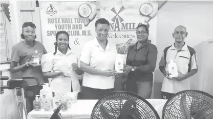  ?? ?? Saintalene Foster hands over the RHTYSC donation to Yonette Yaw in the presence of the staff of the Therapy Unit and Robby Kissoonlal­l of the club.