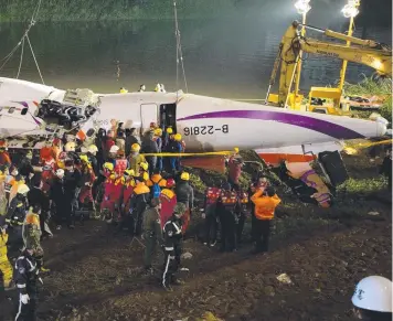  ?? Picture: GETTY ?? CRASH TRAGEDY: TransAsia plane wreckage is pulled from the Keelung River in Taipei.