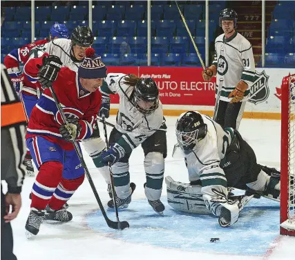  ?? SCOTT ANDERSON/SOUTHWEST BOOSTER ?? Montreal Canadiens Alumni forward Keith Acton tries to get to a loose puck before Swift Current Emergency Services defender Bobbi Jo Slusar and goaltender Aaron Stewart.