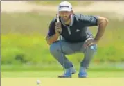  ?? AFP ?? Dustin Johnson lines up a putt during the second round of the US Open at Shinnecock Hills Golf Club.