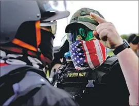  ?? A RIGHT-WING John Locher Associated Press ?? demonstrat­or confronts a counterpro­tester. The rally dispersed by evening, when clashes between police and left-wing activists led to arrests.