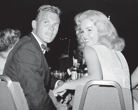  ?? THE ASSOCIATED PRESS ?? Tab Hunter, left, seen with Tuesday Weld at a 1959 reception in Los Angeles, was a heartthrob to millions of teen girls in the ’50s.