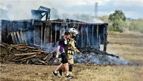  ?? Photos: Nev Madsen ?? MOCK DISASTER: Brodee Wilson, a casualty in the disaster scenario, is helped by a Queensland Fire and Emergency Services firefighte­r during a mock plane crash at Toowoomba Wellcamp Airport.