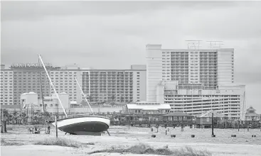  ?? Justin Sellers / Clarion-Ledger via AP ?? A sailboat is beached near the Margaritav­ille and the Golden Nugget casino hotels in Biloxi, Miss., on Sunday, after Nate was the first hurricane to make landfall on the Mississipp­i coast since Katrina in 2005.