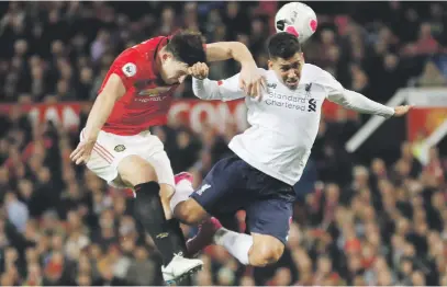  ?? Picture: Reuters ?? AERIAL BATTLE. Manchester United’s Harry Maguire in action with Liverpool’s Roberto Firmino during their Premier League match at Old Trafford yesterday.