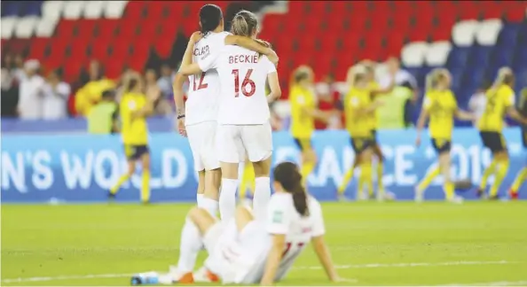  ?? Richard Heathcote/Getty Images ?? Christine Sinclair consoles teammate Janine Beckie after Canada was ousted by the Swedes on Monday at the Women’s World Cup in France. Beckie, just 24 and one of the Canadian team’s emerging stars, was foiled on a penalty shot in a 1-0 defeat.