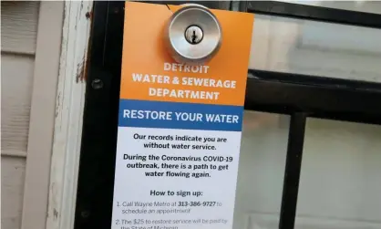  ??  ?? A notice by the Detroit water and sewerage department hangs on a house doorknob to inform residents how to restore service in response to the coronaviru­s outbreak, in March. Photograph: Rebecca Cook/Reuters