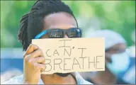 ?? Hearst Connecticu­t Media / Erik Trautmann ?? A protester in Stratford holds a sign that reads “I can’t breathe.”