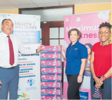  ??  ?? Minister of Health and Wellness Dr Christophe­r Tufton receives 20,000 pads from Gabrielle Sang, marketing manager at Consumer Brands Limited, and non-government­al organisati­on HerFlow founder, Shelly Ann Weekes, during a brief handover ceremony.