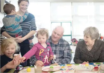  ?? — AFP ?? Prime Minister Theresa May meets attendees at a local parent and toddler group at Heddon-on-the-wall, St Andrew’s Church of England Primary School in Newcastle, on Thursday, during a tour of the United Kingdom.