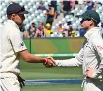  ?? AFP ?? Australia captain Steve Smith (right) shakes hands with England captain Joe Root after the hosts won the second Test. —