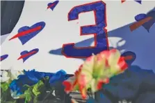  ?? AP PHOTO/AARON DOSTER ?? A sign with the No. 3 of Buffalo Bills safety Damar Hamlin is part of a display of support outside University of Cincinnati Medical Center on Wednesday. Hamlin was taken to the hospital after collapsing on the field during the Bills’ game against the Cincinnati Bengals on Monday.