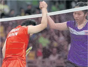  ??  ?? Badminton star Ratchanok Intanon, right, congratula­tes Japan’s Akane Yamaguchi.